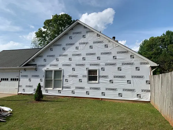 Gable end of a house wrapped in house wrap before new siding goes on