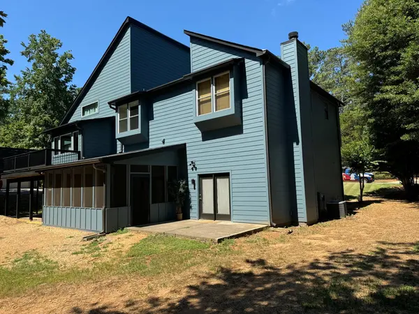 Slate blue painted siding and chimney chase on the rear of a two-story home