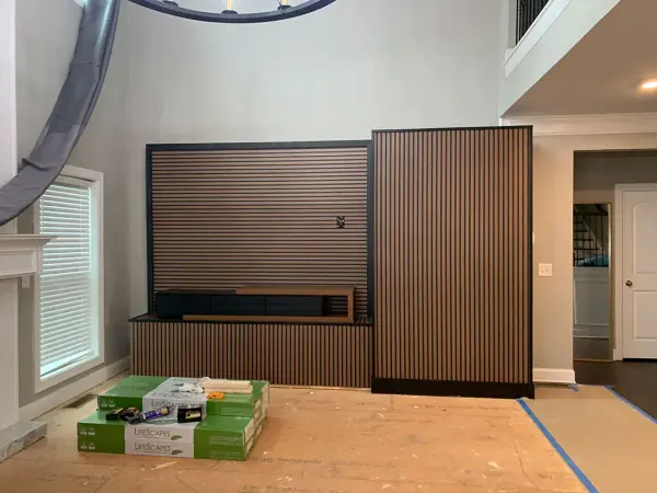 Vertical slat timber feature wall and media unit, underlayment still down on the floor