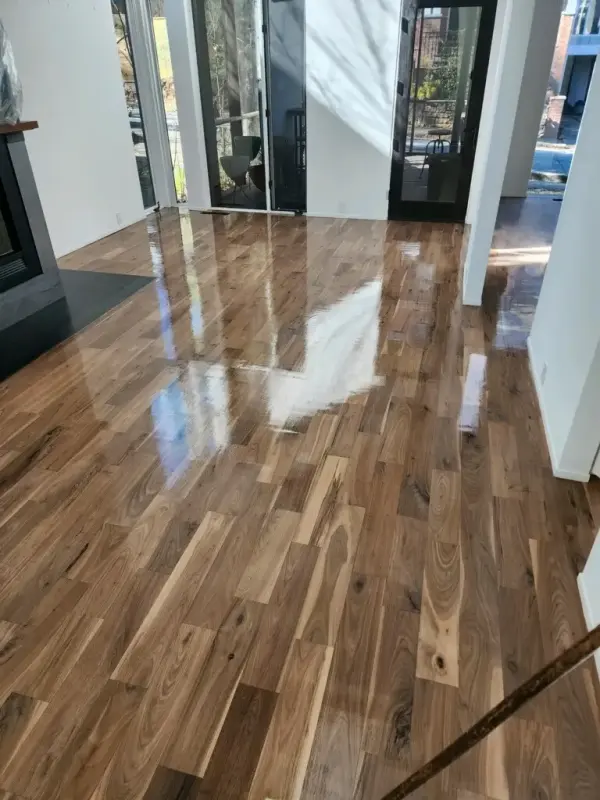 Glossy refinished hickory floor in an open room near a fireplace