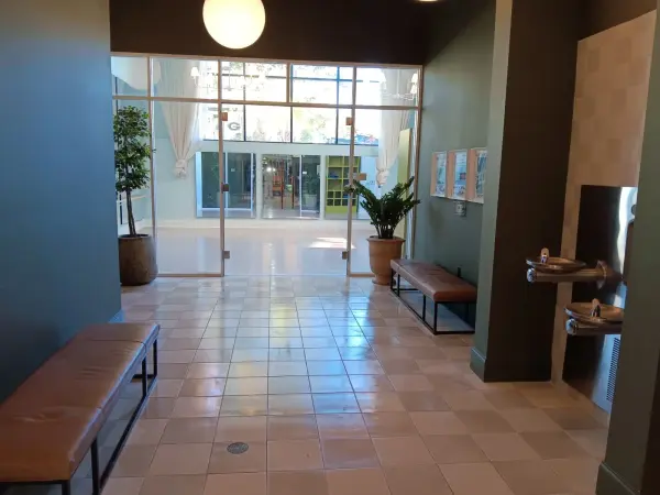 Commercial entry with green walls, a glass storefront and a tile floor